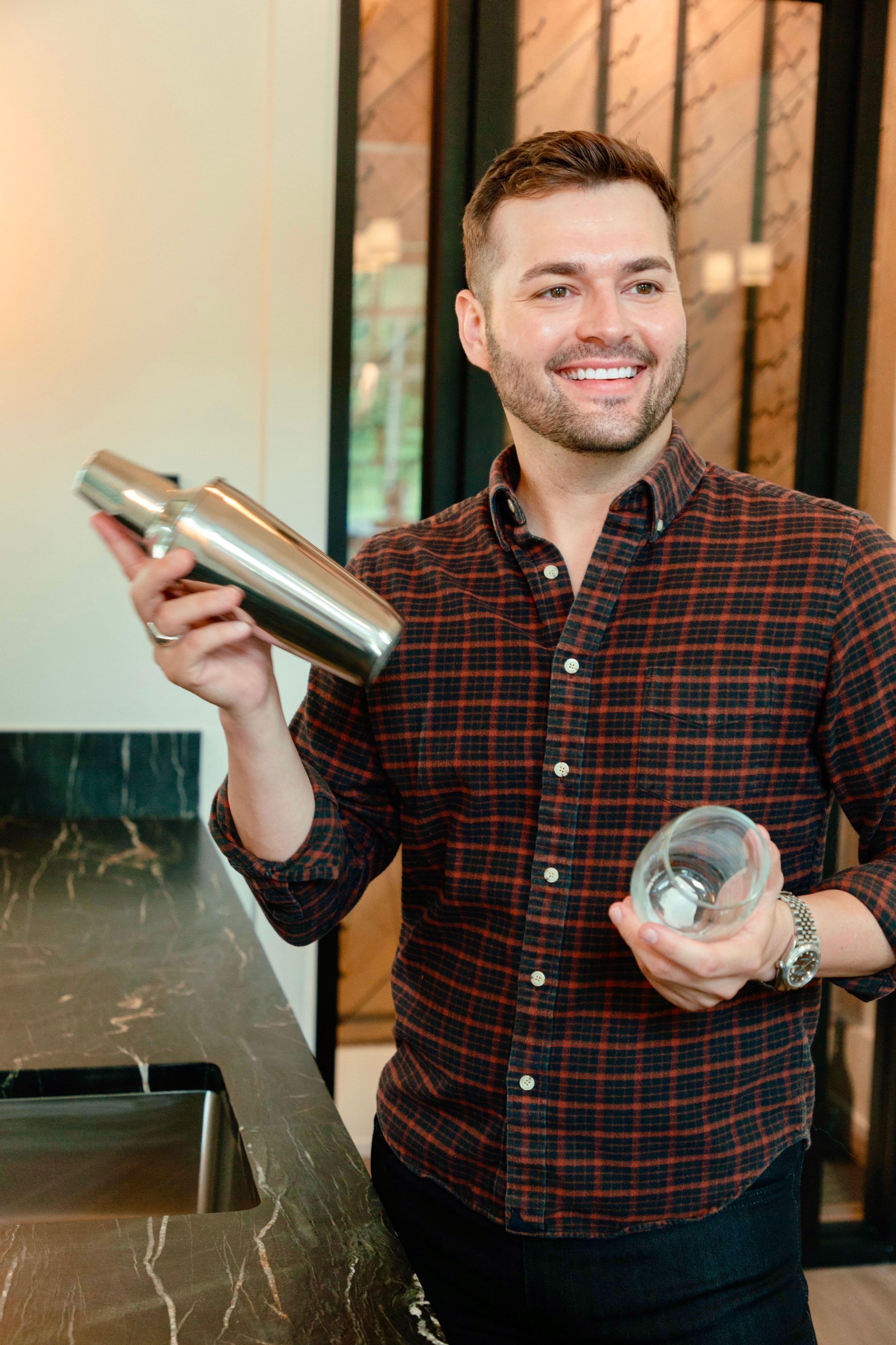 Colton Reid holding a shaker and wine glass