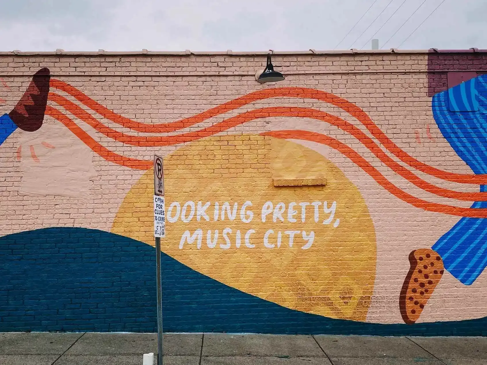 Mural depicting the words, looking pretty, music city in soft and bright colors. 