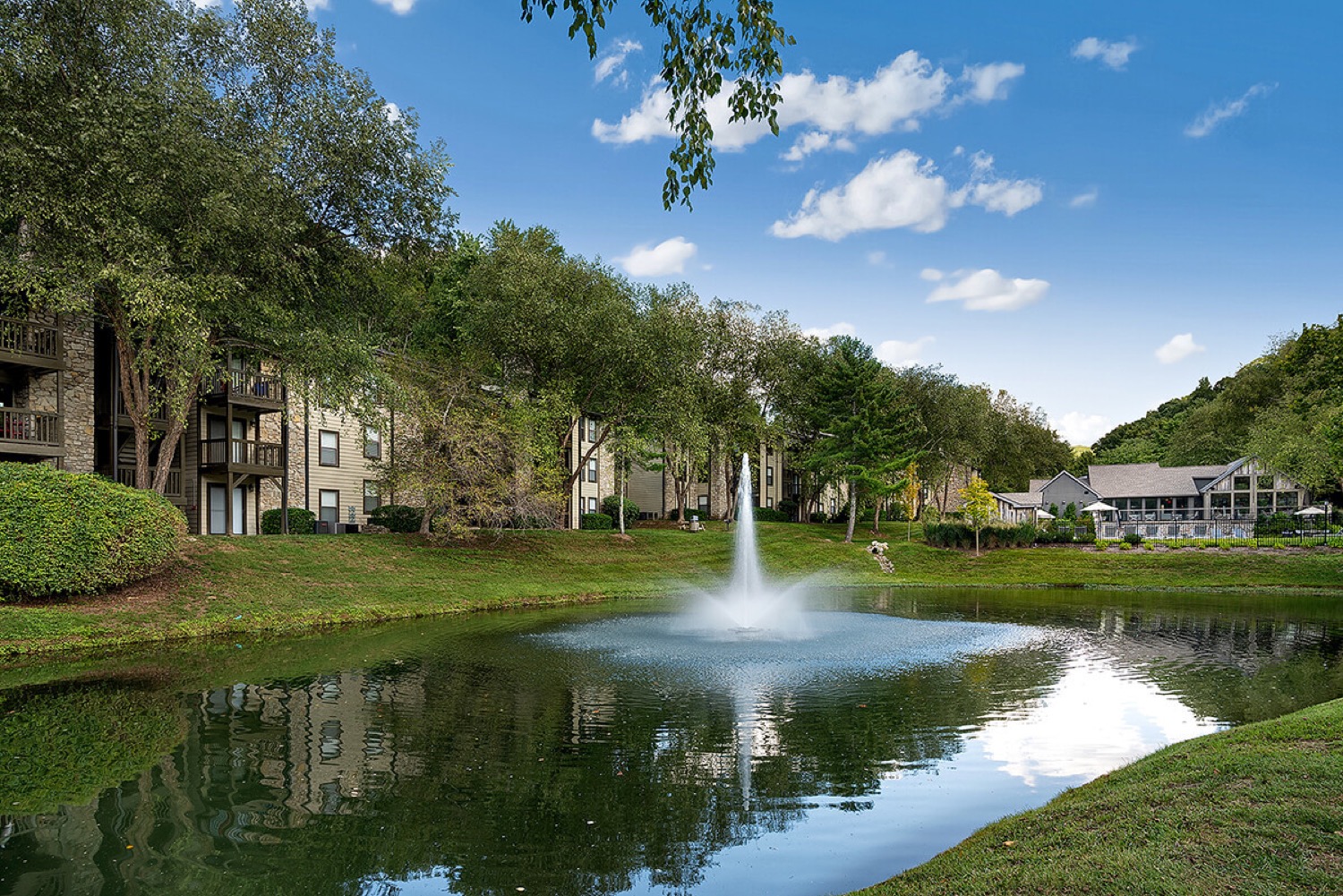 Tree-lined residential pond and fountain at the Lakes of Bellevue in Nashville.