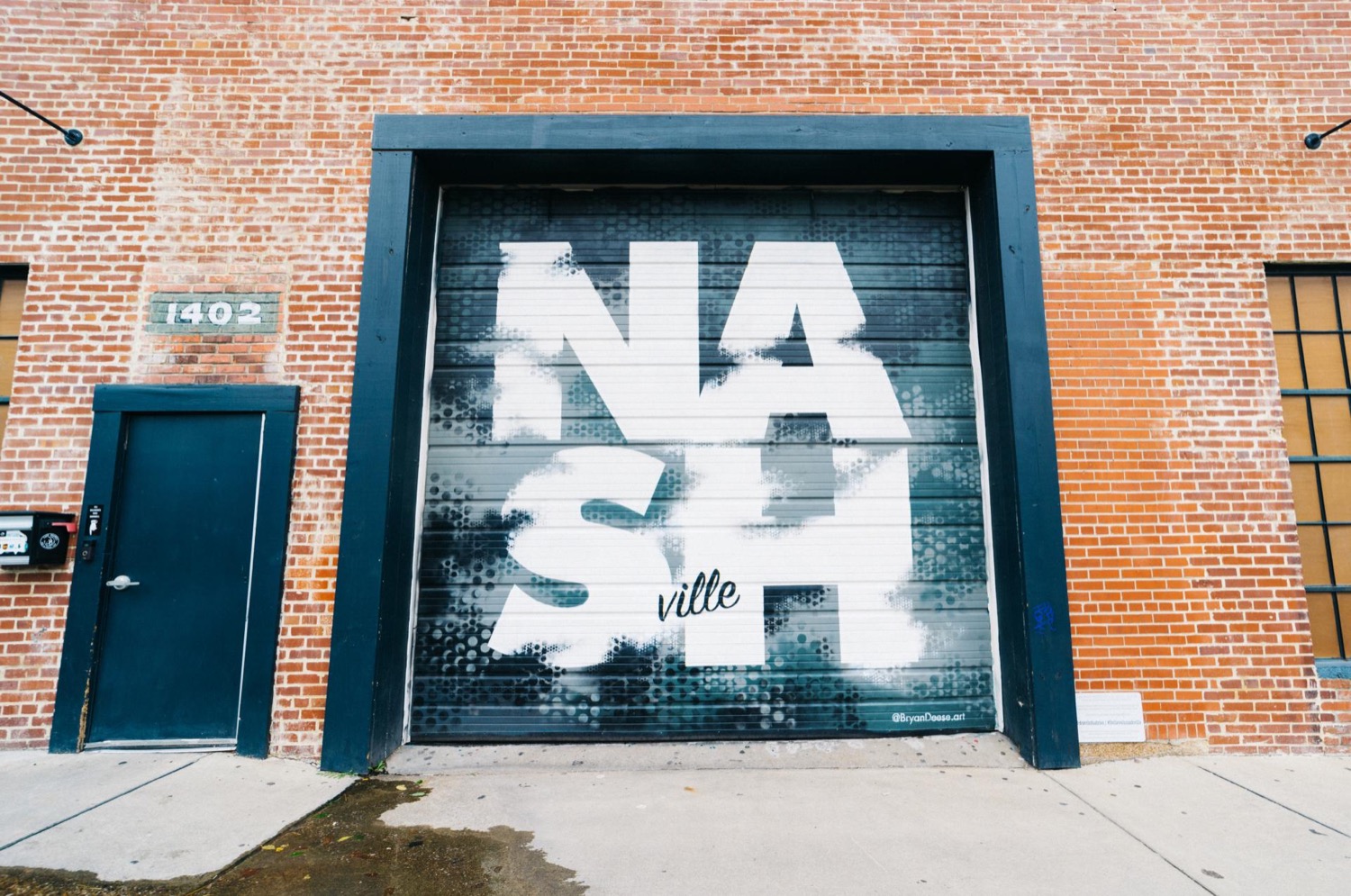 Nashville mural on a brick storefront along Charlotte Avenue.